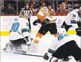  ?? MATT SLOCUM — ASSOCIATED PRESS ?? The Sharks’ Aaron Dell makes a save against the Flyers’ Sean Couturier (14). Dell allowed a goal 48 seconds into the game, then shut out the Flyers the rest of the way.