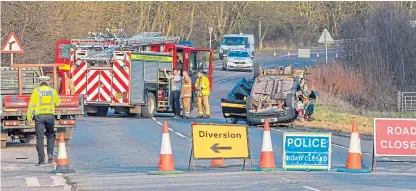  ?? Picture: Steve MacDougall. ?? Emergency services at the scene on the A94 near the junction for Eassie Primary School.