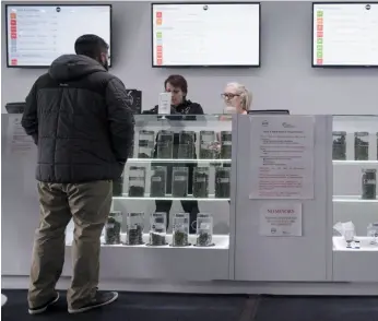  ?? CP FILE PHOTO ?? A customer peruses marijuana products at a dispensary in Vancouver on Jan. 30.