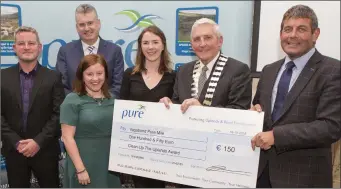  ??  ?? Ciara McGrath and Megan Ruddy of Vagabond Pure Mile accepting the Clean-up the Uplands Award from Ian Davis, Frank Curran, Cllr Pat Vance and Minister Andrew Doyle.