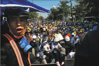  ?? AFP / Getty Images ?? Protesters wearing protective gear take part in a demonstrat­ion against the military coup in Yangon. More than 50 civilians, mostly peaceful protesters, have been killed by security forces.