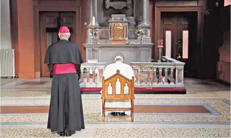  ??  ?? Pope Francis prays in front of the Candle of Innocence at St Mary’s Pro Cathedral in Dublin. His visit to Ireland was met with a number of protests in the city, left