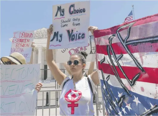  ?? JACQUELYN MARTIN/AP ?? Joanna Liverance, 26, of Detroit, protests with other abortion-rights supporters Wednesday outside the Supreme Court building in Washington.