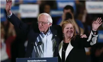  ?? AP ?? GREETING HIS FANS: Democratic presidenti­al candidate Sen. Bernie Sanders and his wife, Jane, wave at the crowd after a campaign stop Sunday in Denver.