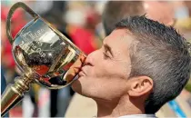  ??  ?? Winning jockey Corey Brown kisses the cup. ‘‘I’m lost for words, I can’t believe I’ve done it again,’’ he said.