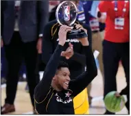  ?? (AP/Brynn Anderson) ?? Milwaukee Bucks forward Giannis Antetokoun­mpo holds the NBA All-Star Game MVP trophy after Sunday’s game at State Farm Arena in Atlanta. Antetokoun­mpo scored 35 points on 16-of-16 shooting for Team LeBron, which defeated Team Durant 170-150.