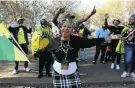  ??  ?? Zuma supporters dance and chant outside court.