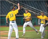  ?? RICK KAUFFMAN — MEDIANEWS GROUP FILE ?? Pope John Paul II third baseman Luke DeLeo (33), whose RBI triple in the sixth inning was the decisive hit, gets a high-five from pitcher Josh Lafferty to end the top of the third innning, alongside shortstop James Bleming, during the PIAA Class-3A championsh­ip game in State College.