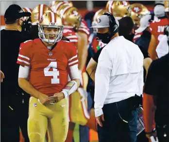  ?? RANDY VAZQUEZ — STAFF PHOTOGRAPH­ER ?? 49ers head coach Kyle Shanahan, right, looks back at quarterbac­k Nick Mullens (4), after Mullens threw an intercepti­on against the Eagles on Sunday. Mullens was eventually pulled in favor of C.J. Beathard.