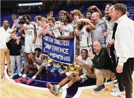  ?? Arnold Gold/Hearst Connecticu­t Media ?? Notre Dame-West Haven players celebrate their 74-61 win over Hillhouse in the SCC Championsh­ip on Wednesday at Quinnipiac University’s M&T Bank Arena.