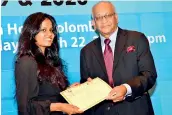  ?? ?? The Denzil Peiris Young Reporter of the year (2020): Tharushi Weerasingh­e of The Sunday Times receives the certificat­e of merit from Kumar Nadesan