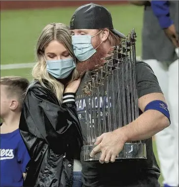  ?? Robert Gauthier Los Angeles Times ?? JUSTIN TURNER, with wife Kourtney, caught heat from around the country when he returned to the field to celebrate the Dodgers’ World Series victory over Tampa Bay after testing positive for the coronaviru­s.