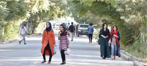  ?? — AFP ?? Afghan university students walk inside of the Kabul University on Saturday, as new talks between the US and the Taliban go on.