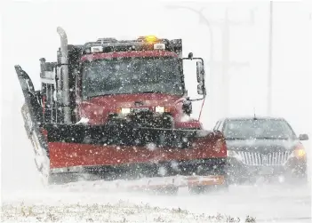  ?? AP KELLY HERTZ/YANKTON PRESS & DAKOTAN VIA ?? A South Dakota state snow plow clears a shoulder along Highway 50 on the north edge of Yankton, S.D., in 2022, as light snow swept by strong winds reduced visibility to a quarter-mile at times.