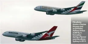  ??  ?? File photo shows a Qantas Airways and an Emirates Airlines Airbus A380 fly in formation during a flyover exercise above Sydney in 2013.