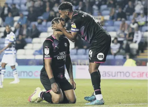  ??  ?? Nathan Thompson consoles Jonson Clarke-Harris after a bad miss as Posh slipped to defeat at Reading.