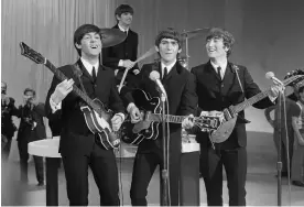  ?? Photograph: CBS photo archive/CBS/Getty Images ?? The Beatles prepare for their first appearance on The Ed Sullivan Show in New York on 9 February 1964.