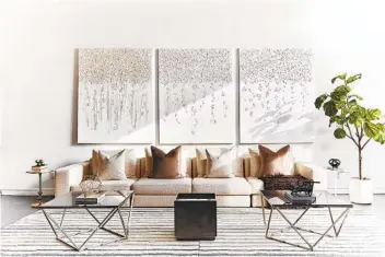 ?? SCOTT GABRIEL MORRIS ?? A three-canvas painting featuring purely white on white steals the show in this modern living space.