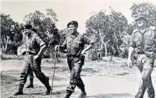  ??  ?? Cooper, left, above centre, and below, in the foreground of the oil painting, The Hook, Korea, by Terence Cuneo, discussing the planning for a new tunnel with a Black Watch platoon commander (who is pointing)