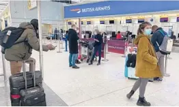  ?? MAXDUNCAN/AP ?? British travelers returning to their homes in Spain wait to speak to airline staff after they were refused entry onto planes Saturday at London’s Heathrow Airport.