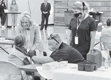  ?? KENNY KEMP Charleston Gazette-Mail ?? First lady Jill Biden talks to a student who received her coronaviru­s vaccinatio­n Thursday during an event at Capital High School in Charleston, West Virginia.