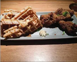  ?? CONTRIBUTE­D BY WENDELL BROCK ?? Ms. Icey’s Kitchen &amp; Bar in Decatur serves a fried chicken dinner with a sweet-potato waffle and a dab of bourbon-praline butter.