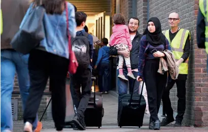  ?? AP ?? Residents leave a tower block on the Chalcots Estate in Camden, London, on Friday evening. —