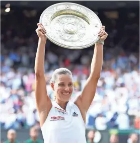  ?? GETTY IMAGES ?? Angelique Kerber lifts the Venus Rosewater Dish after defeating Serena Williams in the women’s singles final at Wimbledon.