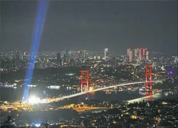  ?? Emrah Gurel/Associated Press ?? A stream of light beams into the sky from near the July 15 Martyrs' Bridge in Istanbul on Saturday to commemorat­e the one-year anniversar­y of the failed coup attempt.