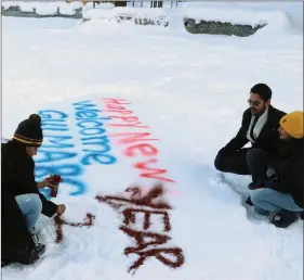  ??  ?? Tourists write Happy New Year on snow on the first day of 2021, in Gulmarg on Friday. ANI