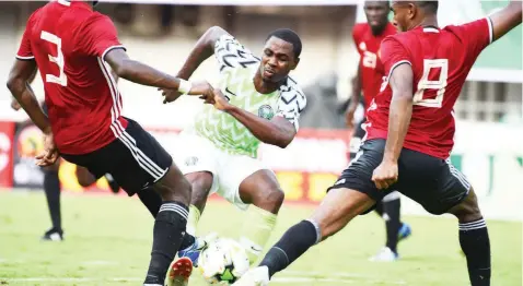  ??  ?? You can’t stop me…super Eagles attacker Odion Ighalo seems to tell three Pirates of Seychelles during their AFCON qualifier in Asaba, Delta State yesterday. The Eagles won 3-1