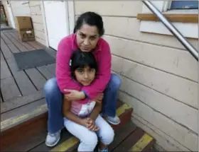  ?? THE ASSOCIATED PRESS ?? Wilma Illanes and her daughter Gabriela Cervantes, 8, pose Wednesday in Sonoma Illanes and her family had to evacuate from there home as a massive wildfire swept through the area last week.