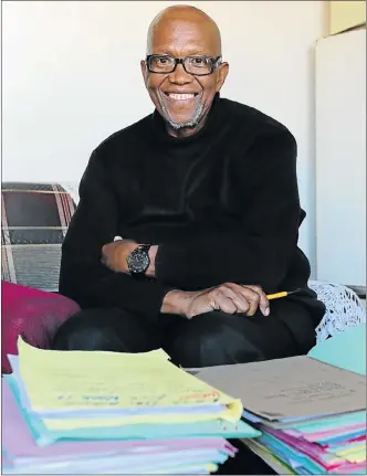  ?? Picture: WERNER HILLS ?? PILES OF WORK: Sabelo Williams with some of the case files he is handling