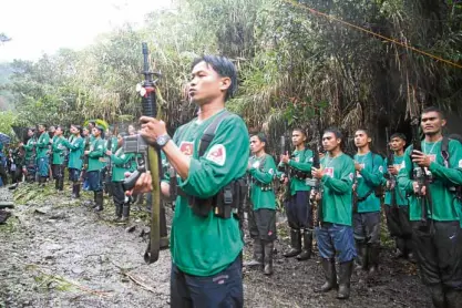  ?? —DENNIS JAYSANTOS ?? SHOWOF FORCE New People’s Army rebels celebrate the Communist Party of the Philippine­s’ founding anniversar­y deep in the forests of Mindanao in this photo taken in 2008.