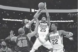  ?? MICHAEL DWYER/AP ?? The Suns’ Mikal Bridges (25) shoots against Celtics’ Derrick White, left, and Al Horford (42) on Friday night in Boston.