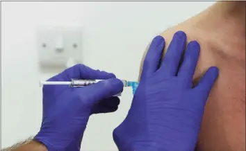  ?? Alastair Grant / Associated Press ?? Phase 3 Novavax coronaviru­s vaccine trial vaccine volunteer Franklyn Howe is given an injection at St. George’s University hospital at in London in October. Novavax Inc. said on Thursday that its COVID-19 vaccine appears 89 percent effective based on early findings from a British study and that it also seems to work — though not as well — against new mutated strains of the virus circulatin­g in that country and South Africa.