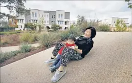  ??  ?? DORIS HAN plays with her grandson at Beacon Park. She treasures their time in a place with “so much peace and with lots of not good English speakers, like me.”