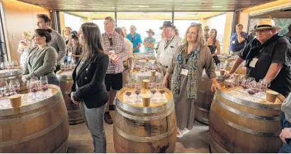  ??  ?? Diverse crowd . . . Otago Daily Times wine columnist Mark Henderson (centre left in checked shirt) at the Pinot Noir Celebratio­n in January 2020.