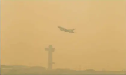  ?? Bianca Otero/Zuma Press Wire/Shuttersto­ck ?? A plane takes off at JFK airport in New York last week amid smoke haze. Similarly conditions could be on their way to the midwest. Photograph: