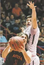  ?? CRAIG FRITZ/FOR THE NEW MEXICAN ?? Capital’s Elias Rodriguez, top, defends Artesia’s Cody Smith during Wednesday’s quarterfin­al game at The Pit. Capital lost 65-63.
