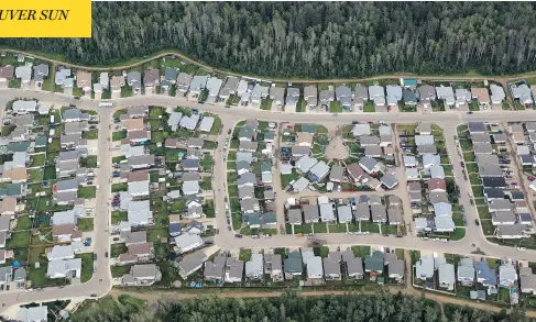  ?? BRENT LEWIN / BLOOMBERG NEWS ?? This 2013 aerial view of a Fort McMurray subdivisio­n shows how little room there is between the dense forest and a residentia­l neighbourh­ood.