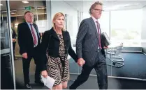  ??  ?? State Services Commission­er Iain Rennie, left, follows Roger Sutton and his wife, Jo Malcolm, into the press conference where Sutton would resign as Cera chief executive.