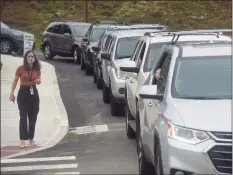  ?? H John Voorhees III / Hearst Connecticu­t Media ?? Beth Grieco, assistant principal, directs parent drop off traffic as students returned fully in-person classes at Ralph M. T. Johnson Elementary School in Bethel on Tuesday morning.