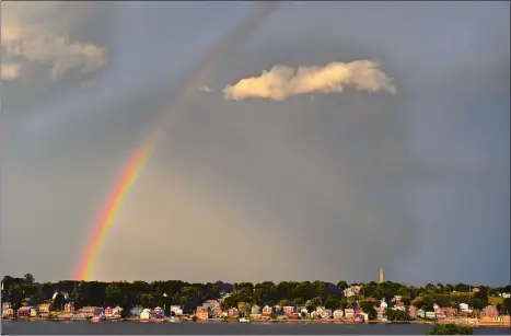  ?? TIM COOK/THE DAY ?? A rainbow is seen over the Groton skyline from New London as a thundersto­rm passes Friday evening to the east of the Thames River.