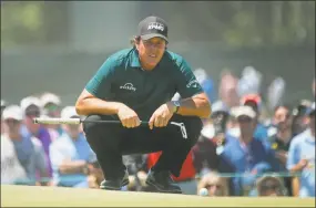  ?? Carolyn Kaster / Associated Press ?? Phil Mickelson lines up a shot on the fourth green during the third round of the U.S. Open on Saturday.