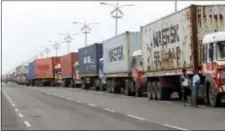  ?? RAJANISH KAKADE - THE ASSOCIATED PRESS ?? Trucks loaded with containers are lined up outside a terminal at the Jawaharlal Nehru Port Trust in Mumbai, India, Thursday. Operations at a terminal at India’s busiest container port have been stalled by the malicious software that suddenly burst...