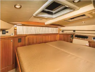  ??  ?? Plenty of overhead hatches and side windows fill the master stateroom with fresh air and light.