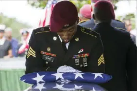  ?? MATIAS J. OCNER — MIAMI HERALD VIA AP ?? Sgt. Donald Young places a U.S. flag over the casket of Sgt. La David Johnson during his burial service at Fred Hunter’s Hollywood Memorial Gardens in Hollywood, Fla., on Saturday. Mourners remembered not only a U.S. soldier whose combat death in...