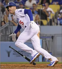  ?? MARK J. TERRILL — THE ASSOCIATED PRESS ?? The Dodgers' Freddie Freeman runs to first base after hitting an RBI double during the fifth inning of Monday's game against the Arizona Diamondbac­ks at Dodger Stadium.