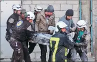  ?? AGENCE FRANCE-PRESSE ?? Syrian civil defence volunteers, known as the White Helmets, carry a comrade who was injured in an air strike while searching for victims of a previous raid in the rebel-held town of Binnish, on the outskirts of Idlib on Saturday.